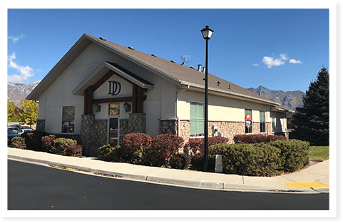 An exterior photo of Doman Dental with mountains.